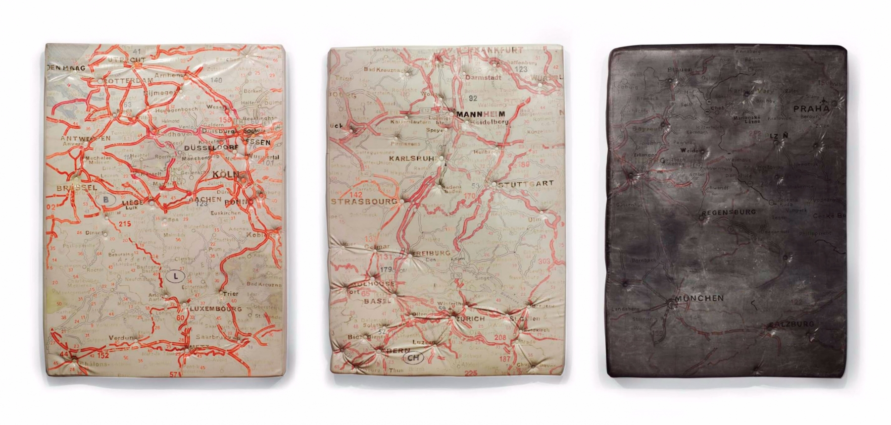 three paintings of maps on mattresses