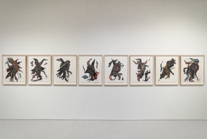 Eight unique and vibrantly colored textile collages hung parallel, each evoking single moving figures, perhaps dancing.