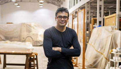 portrait of artist Jitish Kallat in his studio with large sculptures in the background