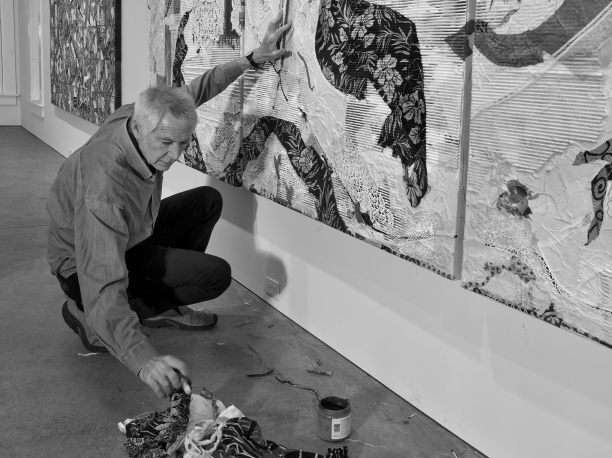 black and white portrait of Peter Sacks working on a large painting in his studio